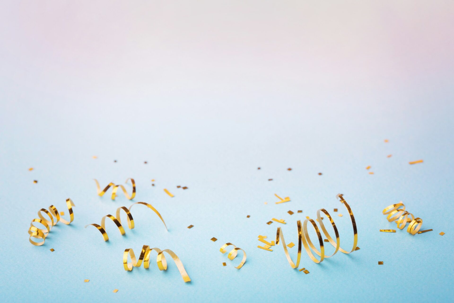 Golden confetti on pink-blue background. decorations for holiday